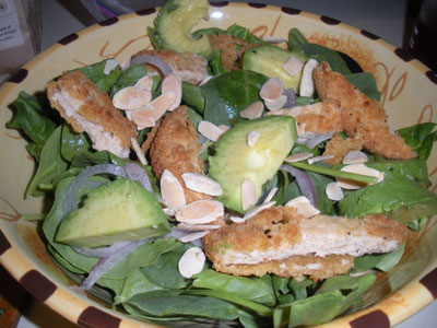 Crispy veggie chicken on spinach salad