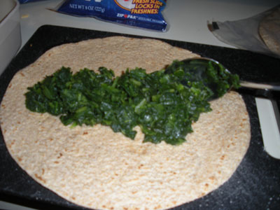 Spread frozen spinach in tortilla shell